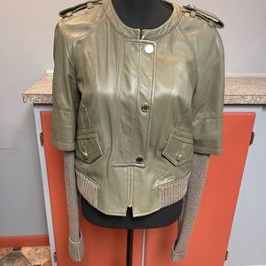 Woman green leather jacket with sweater leaves